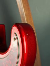 Close-up of a red guitar headstock with a dark background