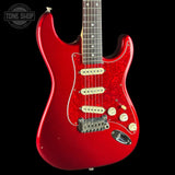 Red electric guitar with a black background