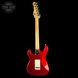 Red electric guitar with a black background