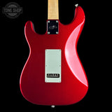 Red electric guitar with a visible brand logo on a black background
