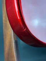 Close-up of a red metallic object with a blurred background