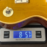 Guitar on a digital scale displaying weight