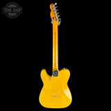 Yellow electric guitar with a black background