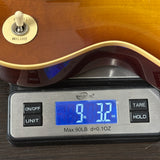 Guitar on a digital scale displaying weight