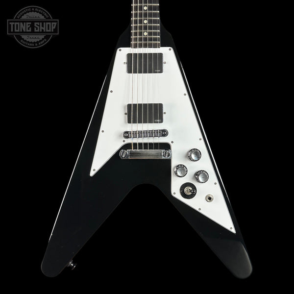 Black and white electric guitar with 'Tone Shop' logo in the corner