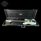A light mint green electric bass guitar inside an open black hard case on a black background, with a Tone Shop watermark in the top left corner.