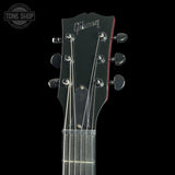 Gibson guitar headstock on a black background with 'Tone Shop' logo.