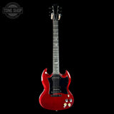 Red electric guitar on a black background with 'Tone Shop' logo.