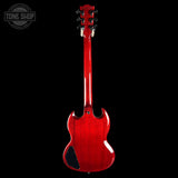 Red electric guitar on a black background with 'Tone Shop' logo.