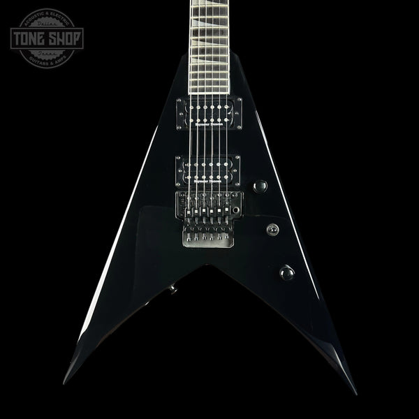 Black electric guitar with a unique design on a black background, featuring the 'Tone Shop' logo.