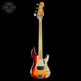 A classic four-string bass guitar with a sunburst finish, featuring a black headstock with a gold logo and a maple neck, shown against a solid black background.