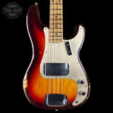 A vintage-style electric bass guitar with a sunburst finish, featuring a dark red outer edge fading to a bright yellow-orange center, a cream pickguard, and a maple neck, shown against a solid black background.