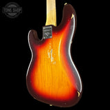 The back of a vintage Fender Stratocaster electric guitar with a classic sunburst finish, showing a black background and a Tone Shop watermark in the top left corner.