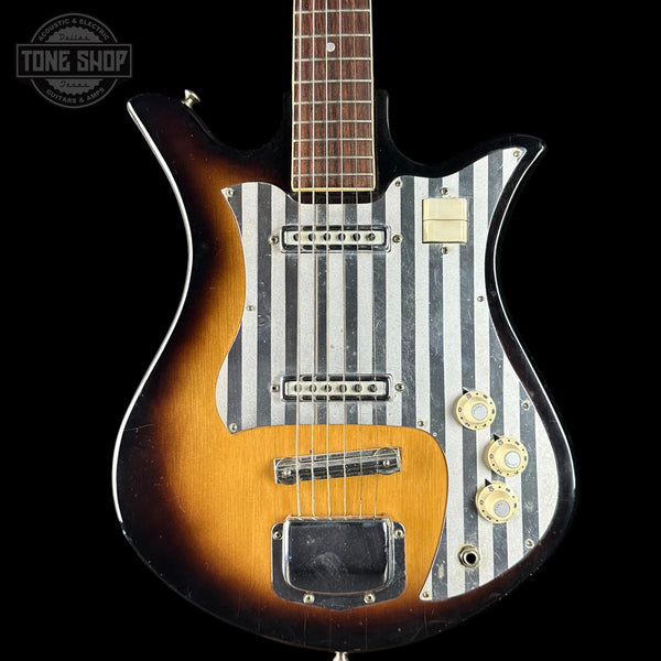 Guitar with striped body design on a black background, featuring 'Tone Shop' branding.