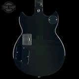 Back view of a black electric guitar with 'Tone Shop' logo in the corner.
