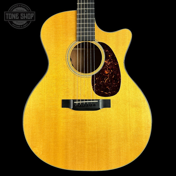 Acoustic guitar with a visible brand logo on a black background