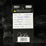 A product tag for aPRS Studio Instruments Tremati Stopper1 guitar string set, placed on a black furry surface. The white paper tag contains handwritten details in blue ink and features the PRS logo at the top.