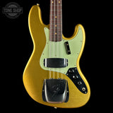 A gold Fender Strat bass guitar with a mint green pickguard and black hardware, shown against a solid black background with a Tone Shop watermark in the top left corner.