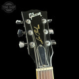 Gibson Les Paul guitar headstock with brand logo on a black background