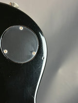 Close-up of a black object with a metallic component on a gray background