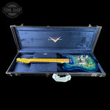 An electric guitar with a blue floral body and a yellow maple neck, displayed inside an open black hard case with a blue velvet interior. The case lid features a white 'Custom Shop' logo, and a Tone Shop watermark is visible in the top-left corner.