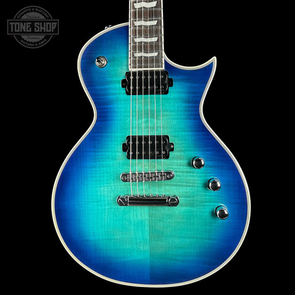 Blue electric guitar with a gradient finish on a black background, featuring the Tone Shop logo.