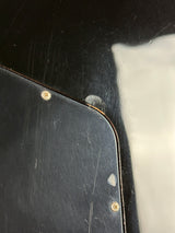 Close-up of a black surface with a scratch and two screws.