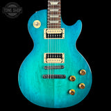 Turquoise electric guitar on a black background, featuring 'Tone Shop' logo.