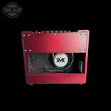 A red crocodile-embossed guitar amplifier cabinet shown from the front against a solid black background, with a visible speaker and control knobs at the top.