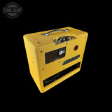 A yellow textured guitar amplifier cabinet shown at an angle on a solid black background, with a Tone Shop watermark in the top-left corner.