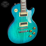 Turquoise electric guitar with gold hardware on a black background, featuring 'Tone Shop' logo.