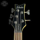 Guitar headstock with Schecter branding on a black background