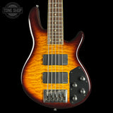 Electric bass guitar with a sunburst finish on a black background, featuring the Tone Shop logo.