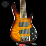 Electric bass guitar with a sunburst finish on a black background, featuring the Tone Shop logo.