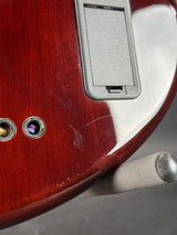 Close-up of a guitar's headstock and tuning pegs with a wooden finish.