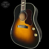 Acoustic guitar with a sunburst finish on a black background, featuring the Tone Shop logo.