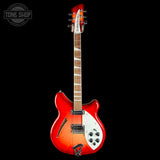 A red and orange sunburst electric guitar with a white pickguard, shown vertically against a solid black background. The brand name 'Rhythm Zone' is visible on the headstock, and a 'Tone Shop' watermark is in the top-left corner.