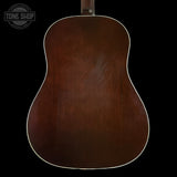 Back view of a wooden acoustic guitar with 'Tone Shop' logo in the corner.