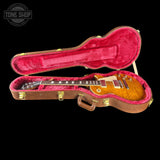 Gibson Les Paul guitar in a red-lined case with 'Tone Shop' logo.