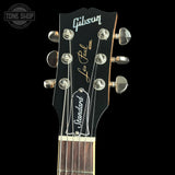 Gibson Les Paul guitar headstock with brand logo on a black background