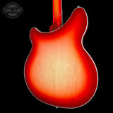 Close-up of the back of a double-cutaway electric guitar showing a sunburst finish that transitions from bright red-orange to a warm natural wood tone. The neck is visible at the top, and a Tone Shop watermark is in the upper left corner against a solid black background.