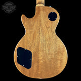 Wooden guitar body with a 'Tone Shop' logo in the corner