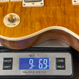 Guitar on a digital scale displaying weight