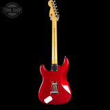 Red electric guitar with a black background