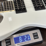 White electric guitar on a digital scale displaying weight