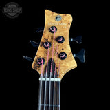 Bass guitar headstock with 'Marcus Miller' branding on a black background