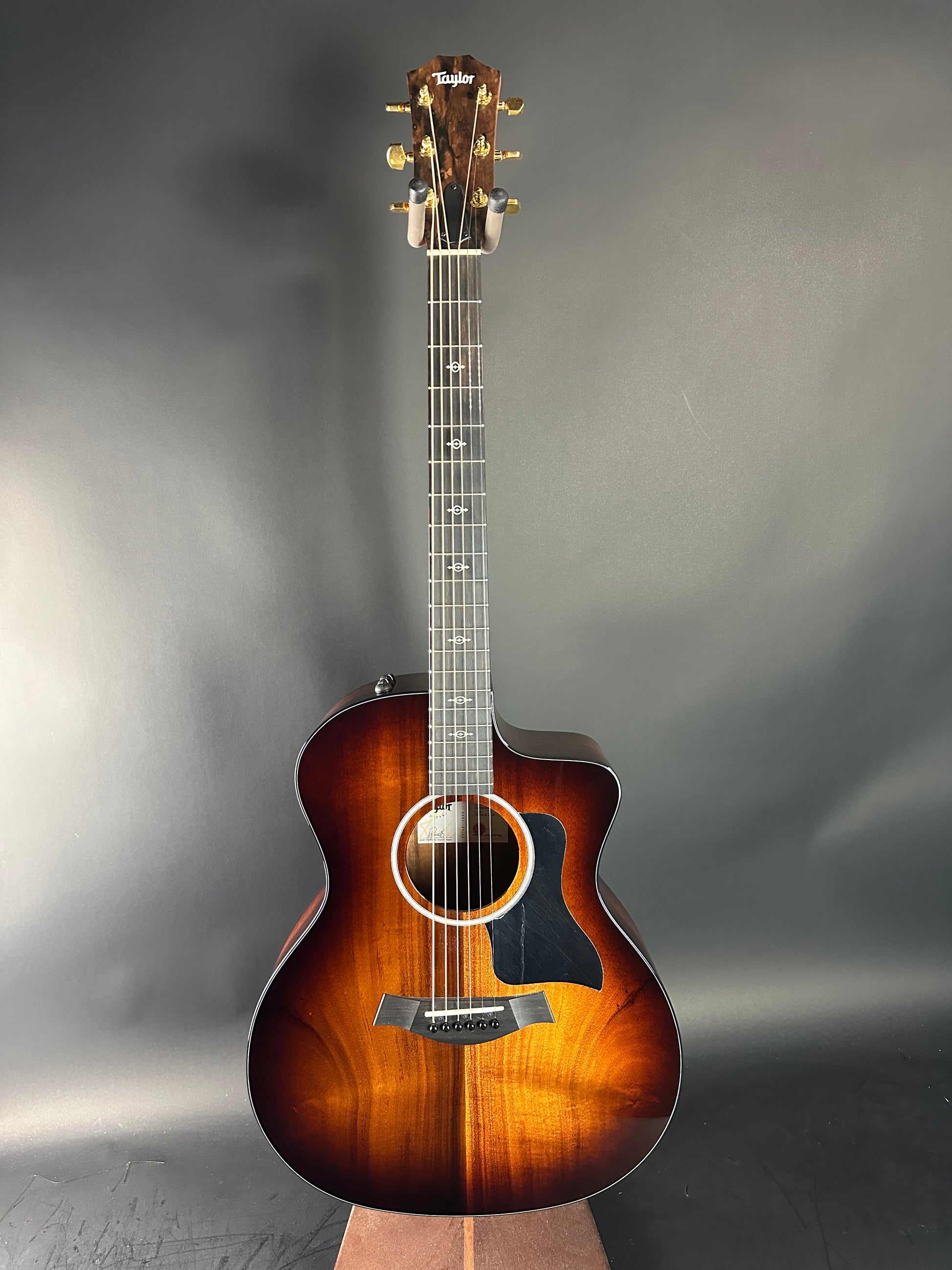 Acoustic guitar with a sunburst finish on a gray background