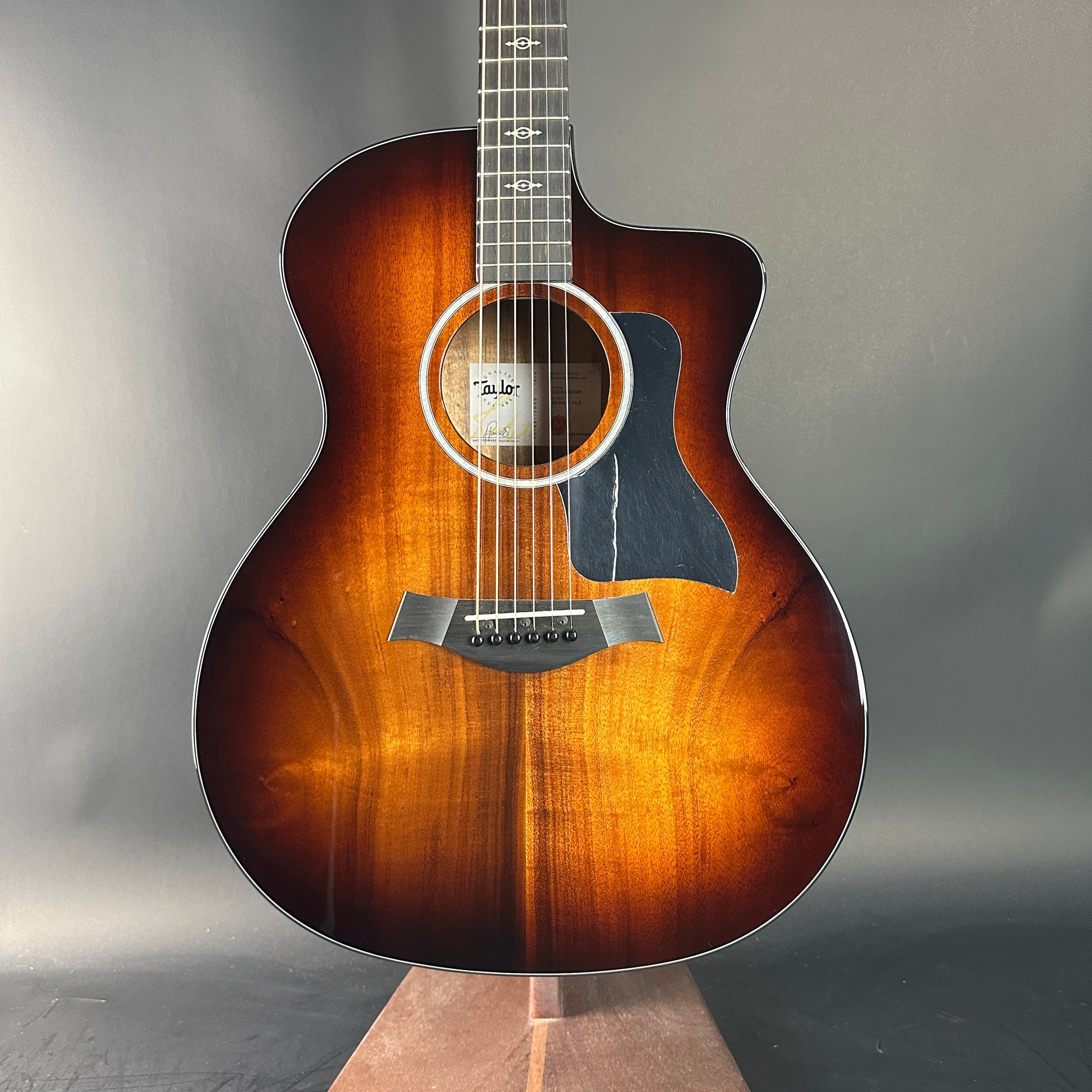 Acoustic guitar with a sunburst finish on a gray background