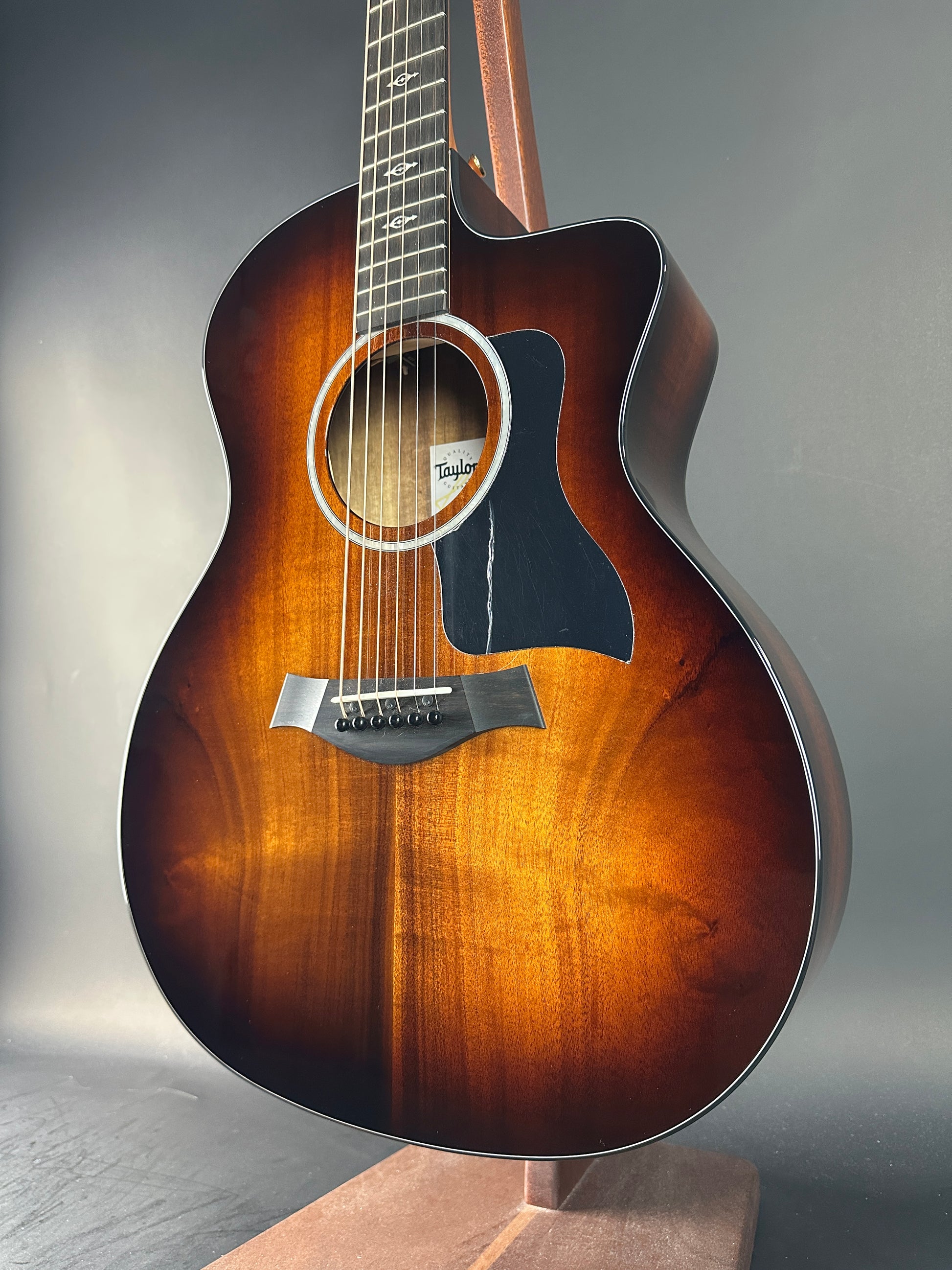 Acoustic guitar with a sunburst finish on a gray background