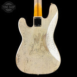 The back of a Fender Stratocaster electric guitar with a heavily distressed, weathered cream finish and black speckling, shown against a solid black background.